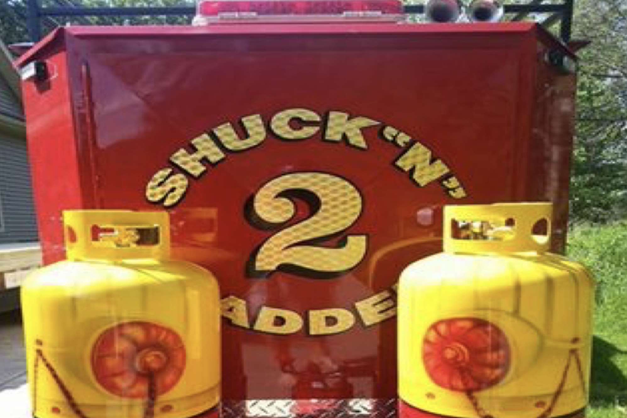 A red and yellow Texas corn-roasting machine, lovingly named “Shuck’n Ladder #2”